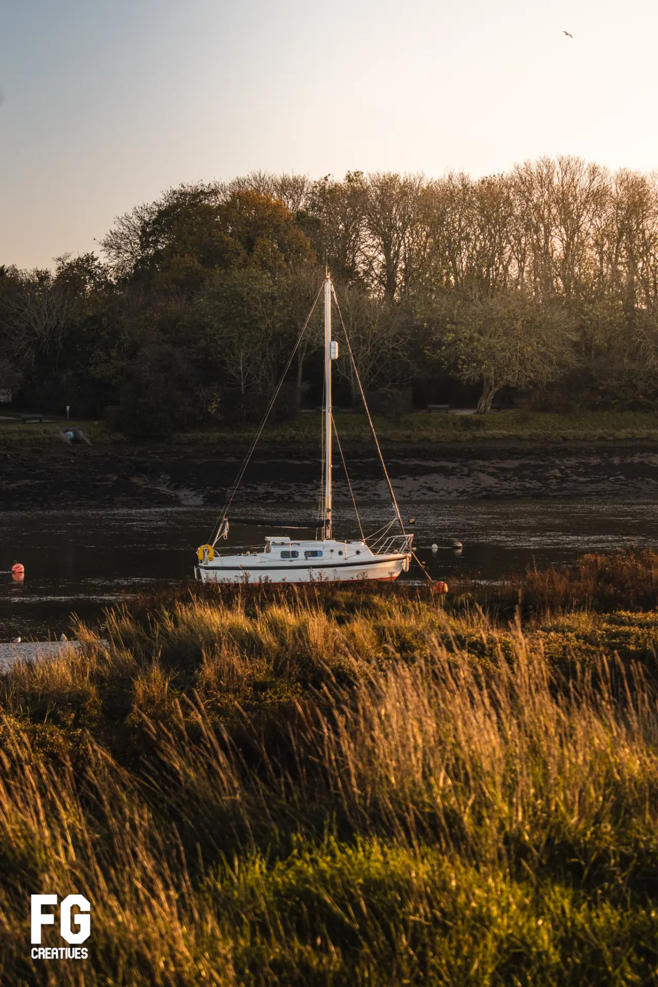 Sailing boat moored on an Essex river at golden hour